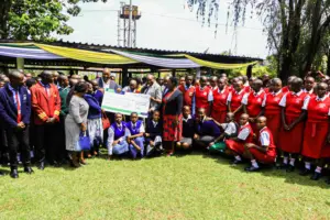 Students from various secondary schools pose for a photo with Governor Nyaribo as they display a dummy cheque of KSh. 66 million awarded to them. A total of 22,000 students will benefit from these bursaries. Photo/Arnold Ageta