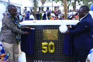 Manga Sub County TSC Director Michael Fuaya and Principal Job Rasugu inaugurate the 50th anniversary monument. Photo/Arnold Ageta