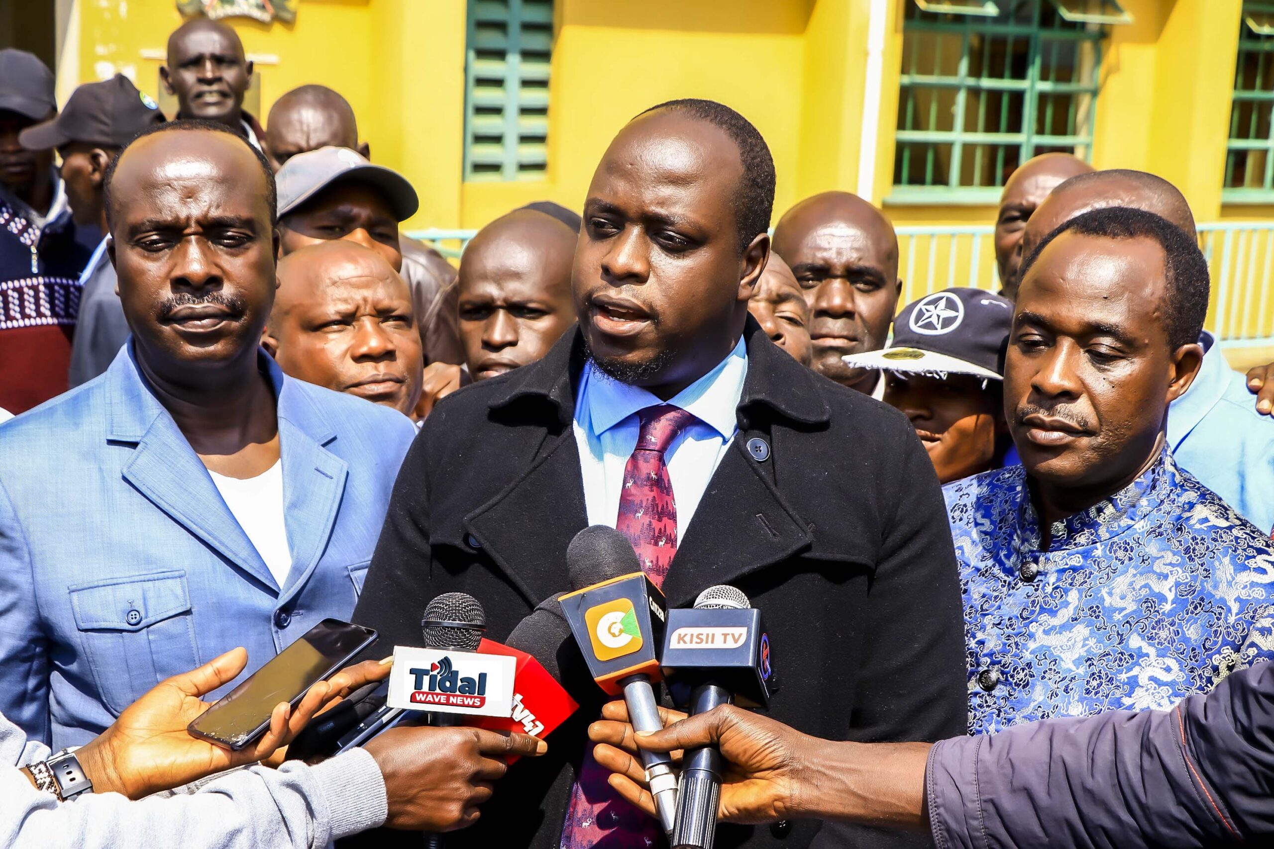 From left: Lawyer Danstan Omari, Stanley Kinyanjui, and West Mugirango MP Stephen Mogaka address the media outside Nyamira Law Courts after filing a petition challenging President Ruto’s declaration of Kiabonyoru as the site for the proposed Nyamira University. Photo/Arnold Ageta