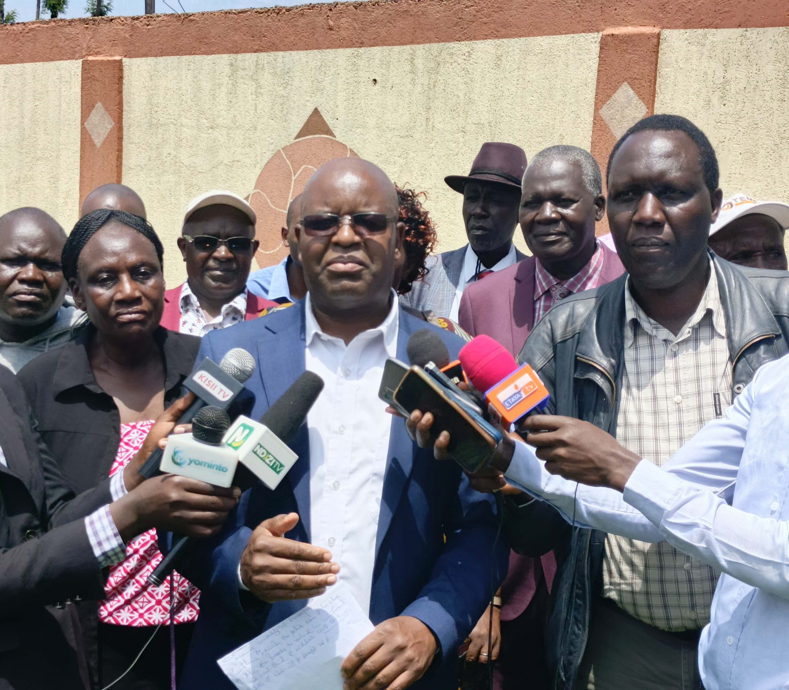 Dr. Densford Maendo (wearing glasses) addressing the media in Nyamira as they rallied support for North Mugirango MP Joash Nyamoko and President Ruto's declaration of Kiabonyoru as the site for the proposed Nyamira University. Photo by Arnold Ageta.