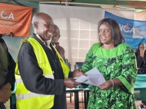 Jerusha Momanyi issuing an accreditation certificate to one of the beneficiaries of the NCA skilled labor training at Nyamira Boys in West Mugirango Constituency. Photo/Arnold Ageta