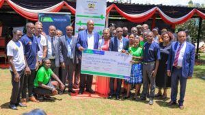 Nyamira Governor Amos Nyaribo (center), flanked by KCB Bank and KCB Foundation officials, students, and other county leaders, poses for a photograph at the launch of the 2Jiajiri Scholarship Program in Nyamira.