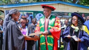 Governor Amos Nyaribo hands a completion certificate to a graduate of the County Youth Digital Empowerment Programme during a ceremony held at the Nyamira County Headquarters. Photo/Arnold Ageta
