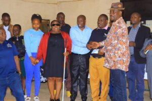 West Mugirango MP Stephen Mogaka and members of a beneficiary group pose for a photo during the issuance of Uwezo Fund cheques at Kebirigo Boys High School. Photo/Arnold Ageta