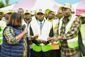 Nyamira County Woman Representative Jerusha Momanyi issues a cheque to Magwagwa Stage B boda boda leaders during an empowerment programme. Photo/Arnold Ageta